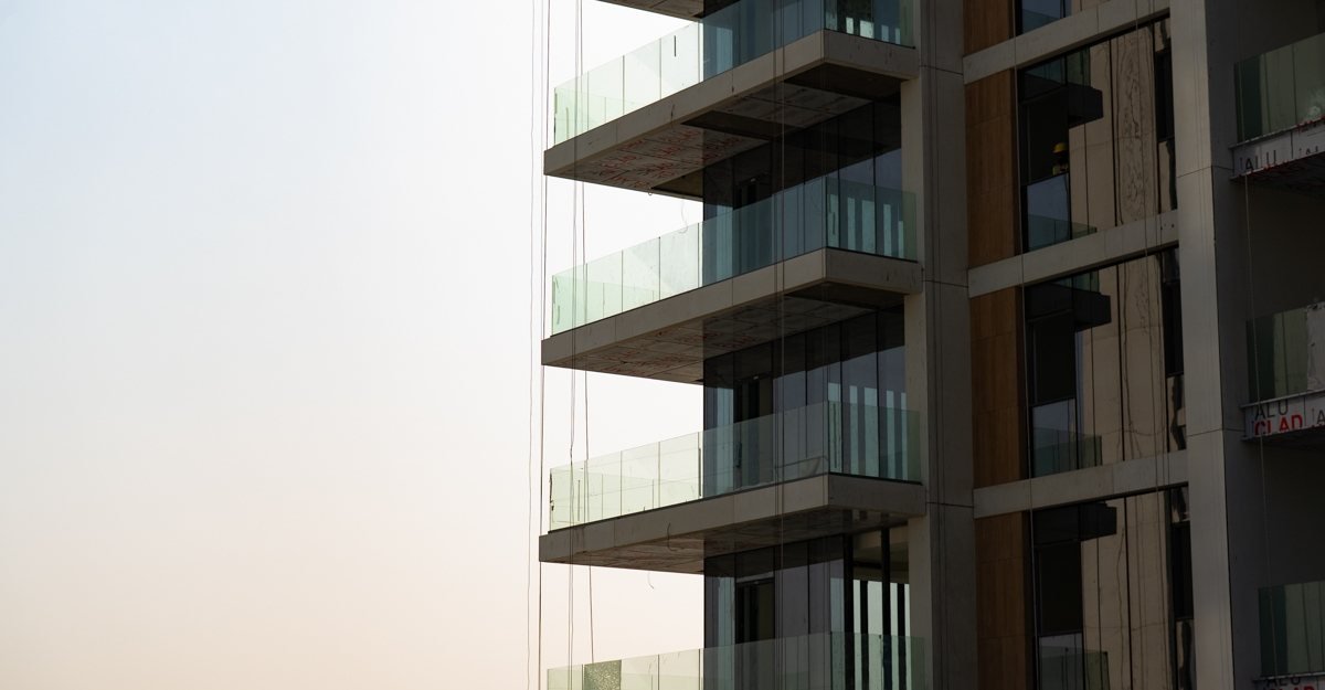 Naya Residences towers rising beside the lagoon